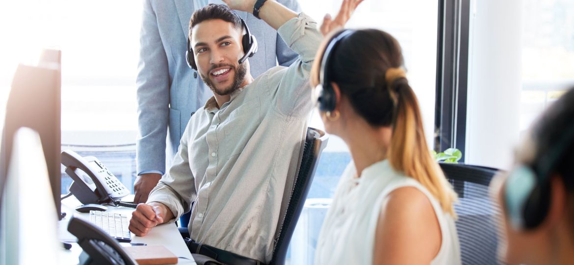 High five, success or happy man in call center for deal bonus, winning online or victory good news. Coworking, people or excited inbound agent consulting for telemarketing target and sales target